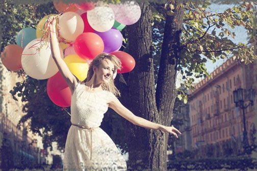 StandUpGirl girl holds cluster of balloons