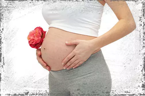 StandUpGirl pregnant woman holds belly and flower