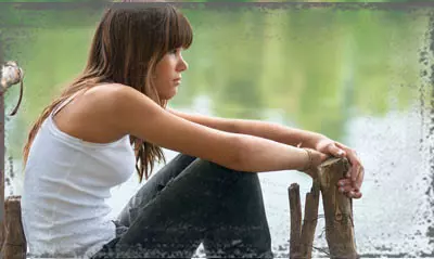 StandUpGirl woman sits by water