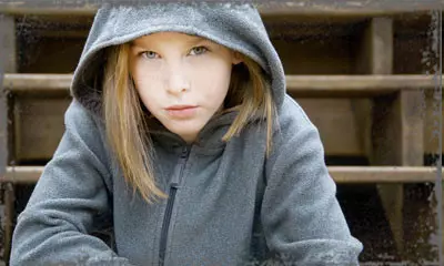 StandUpGirl girl with hood up looks at camera
