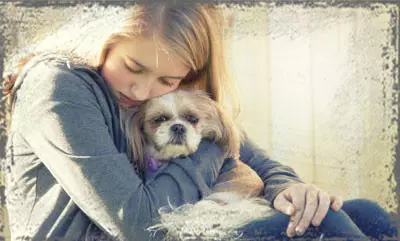 StandUpGirl woman cuddles a dog in arms