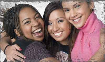 StandUpGirl three women smile hugging