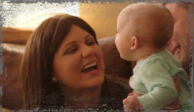 StandUpGirl woman smiles looking at baby