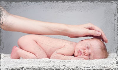 StandUpGirl arm on top of newborn baby