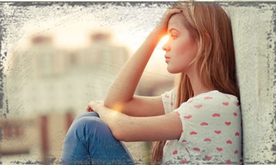 StandUpGirl girl sitting against wall hand on head