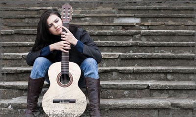 StandUpGirl girl with guitar on steps