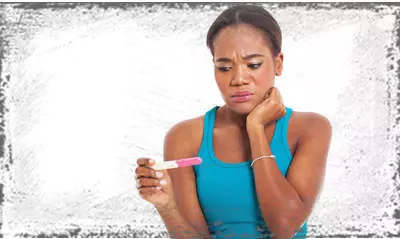 StandUpGirl women looks at pregnancy test results