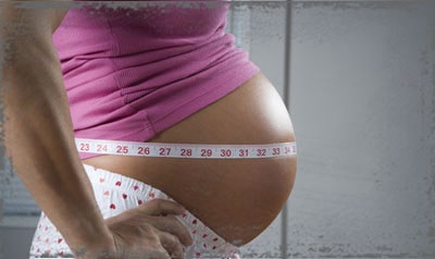 StandUpGirl tape measure around pregnant belly